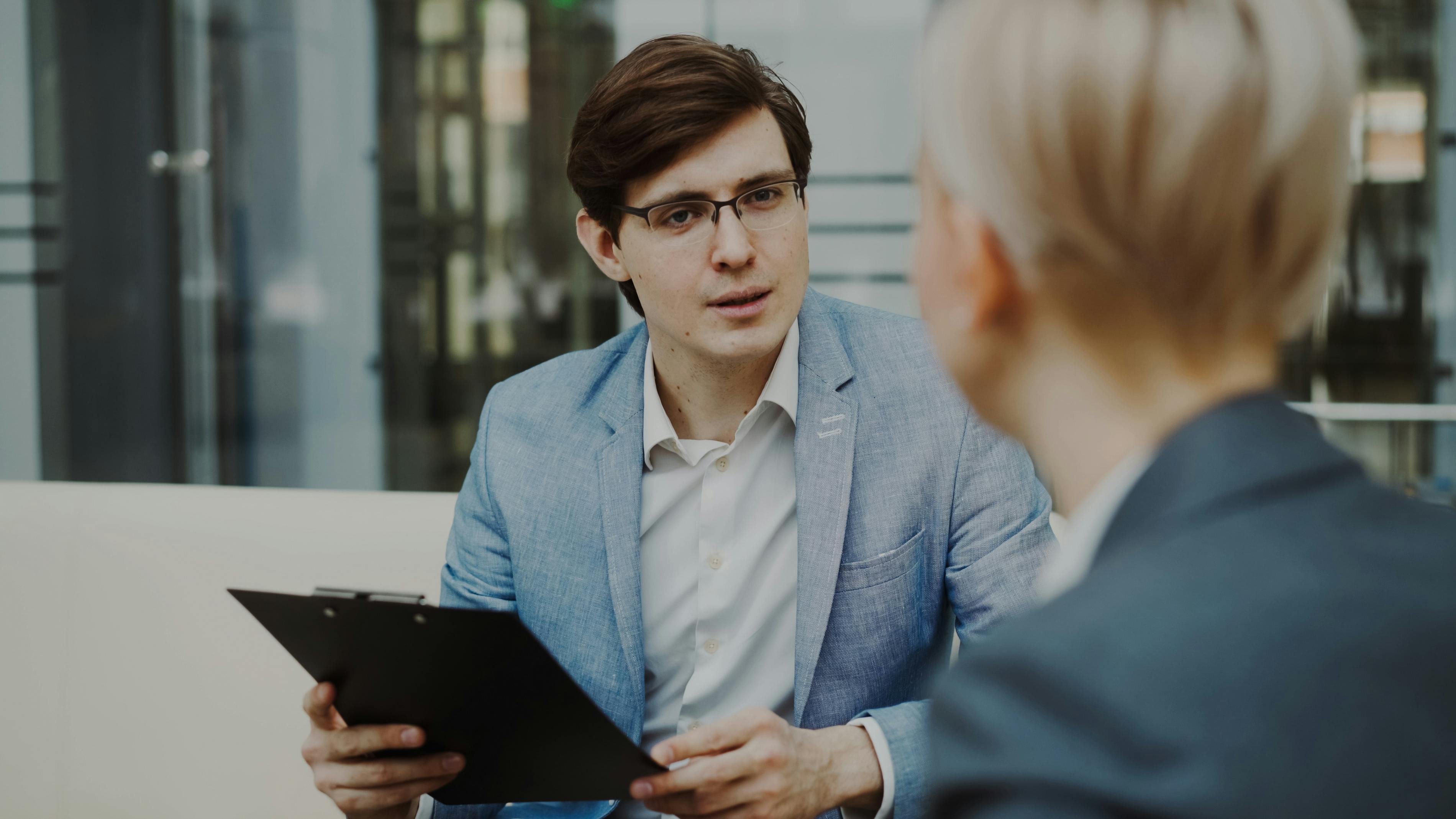 Business professionals engaged in a meeting inside a modern office setting.